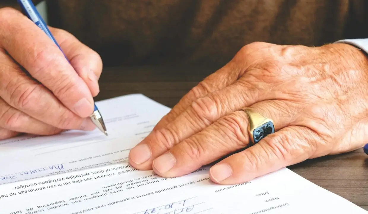 Image: man signing contract